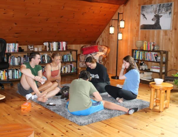 teens on floor of loft cottage playing games