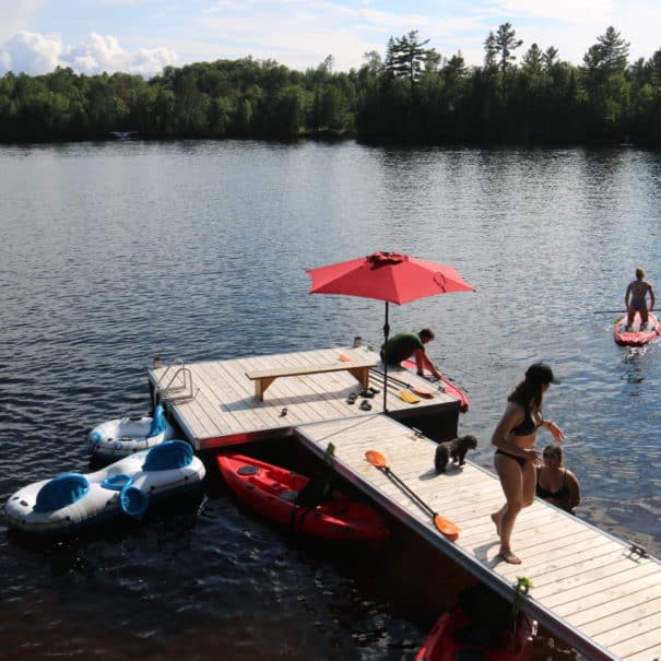 teens on dock playing in water