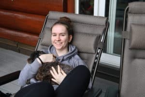 girl holding black dog