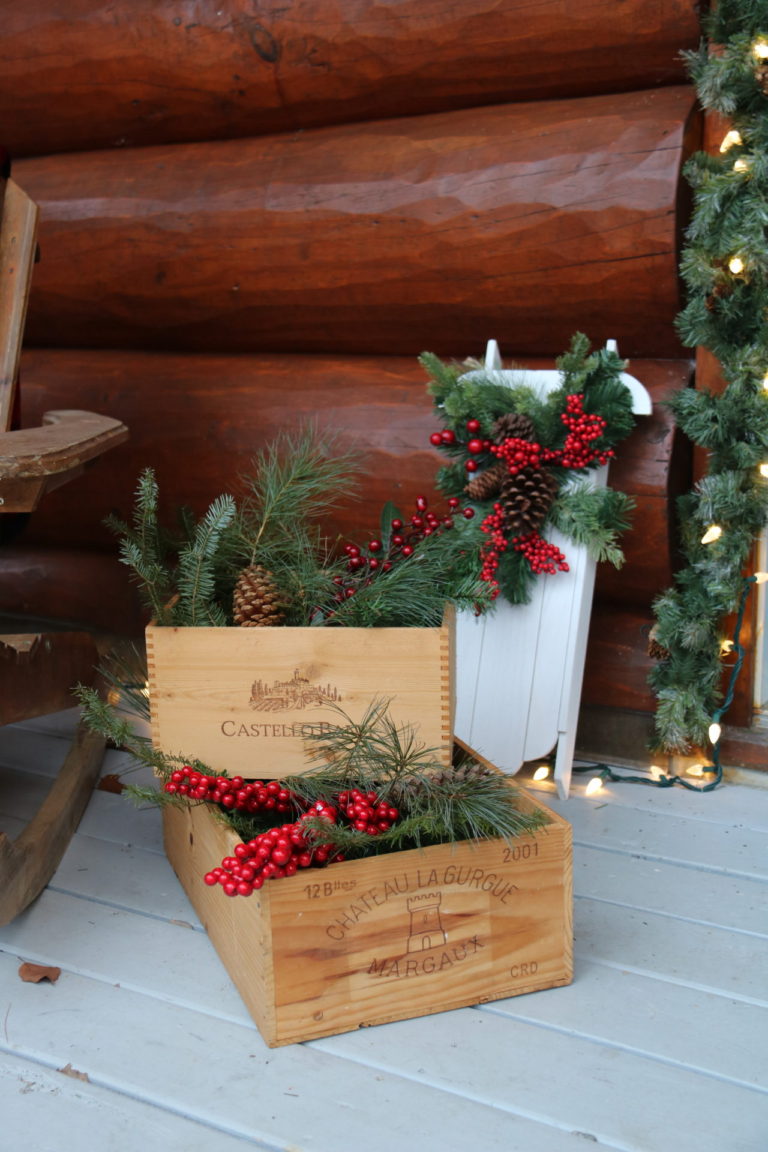 wooden boxes outdoors decorated with pine and berries at Quebec cottage rental