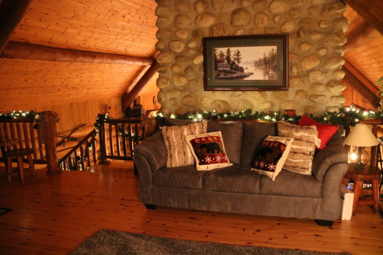 grey couch with christmas lights behind