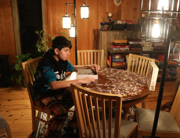 boy doing puzzle in loft cottage rentals near ottawa