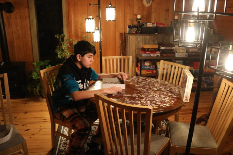 boy doing puzzle in loft cottage rentals near ottawa