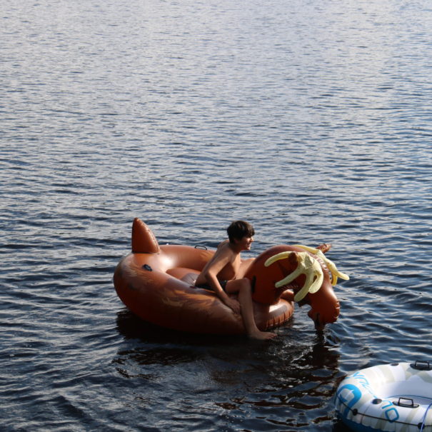 boy on moose float at cinnamon lodge quebec