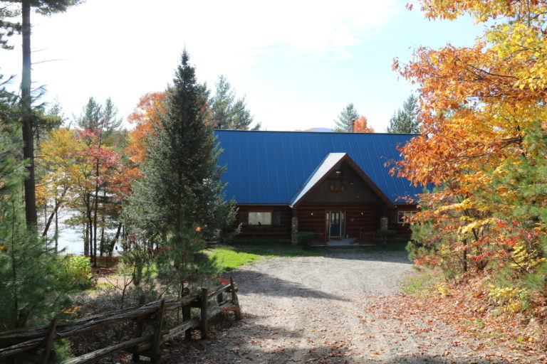 log cottage blue roof