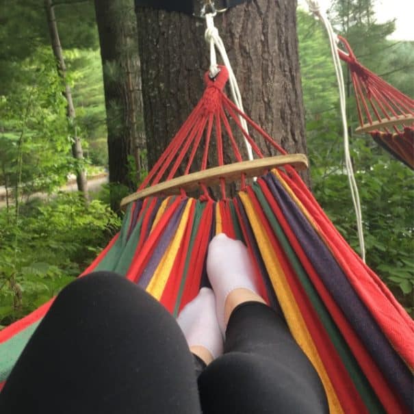 girl with black leggings on colourful hammock