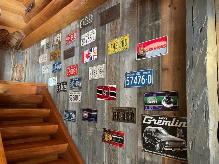 old licence plates on barn board wall