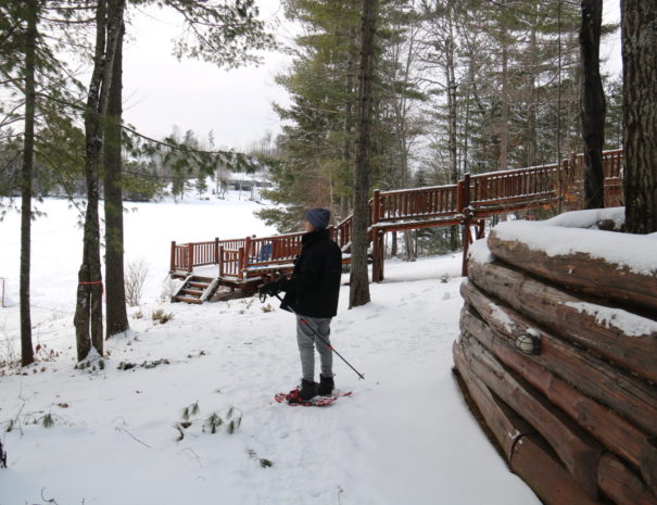 boy snowshoeing in winter at Quebec cottage rental