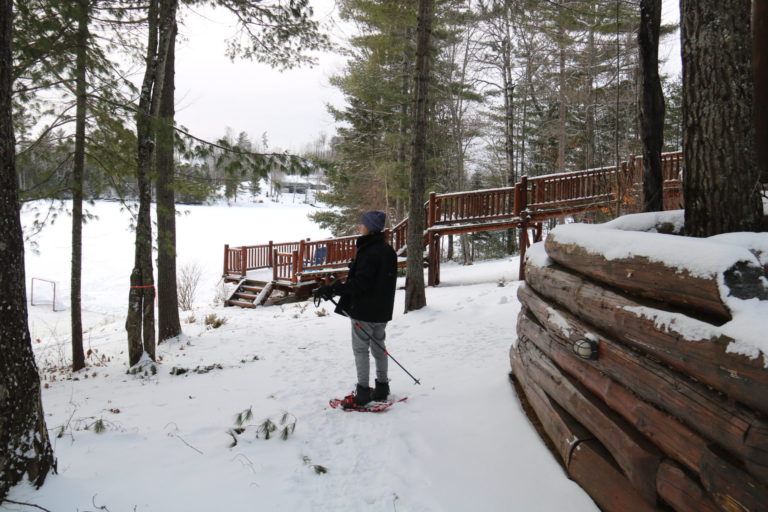 boy snowshoeing in winter at Quebec cottage rental